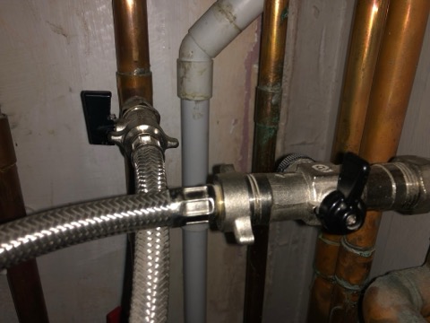 The two black filling-loop taps below the boiler